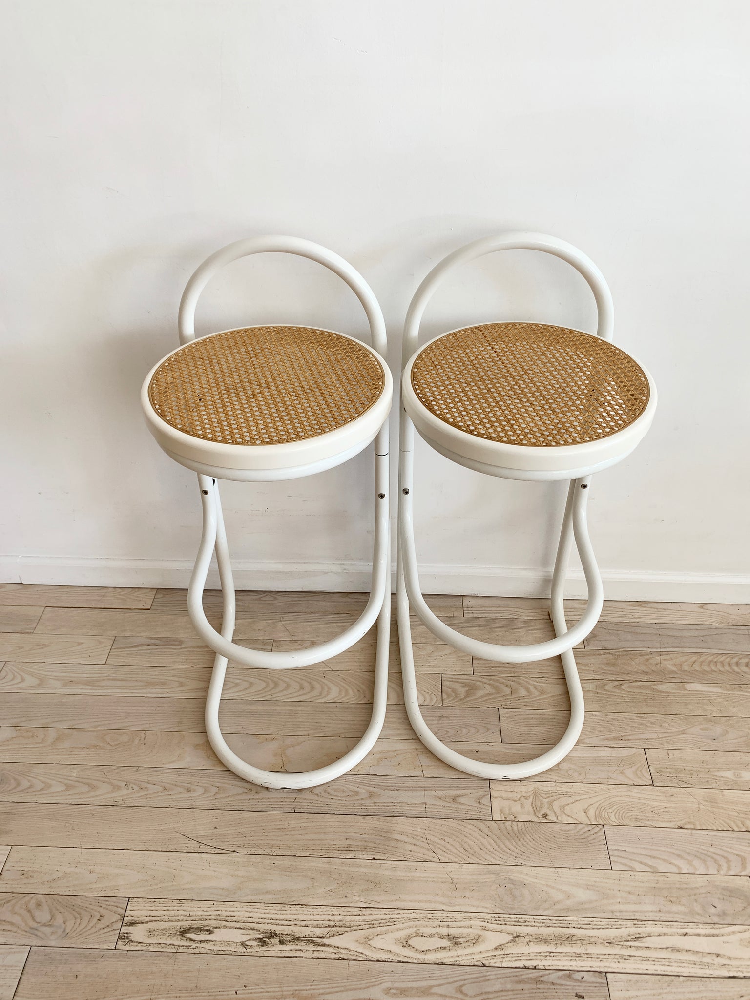 Pair of Vintage White Bent Metal and Cane Bar Stools
