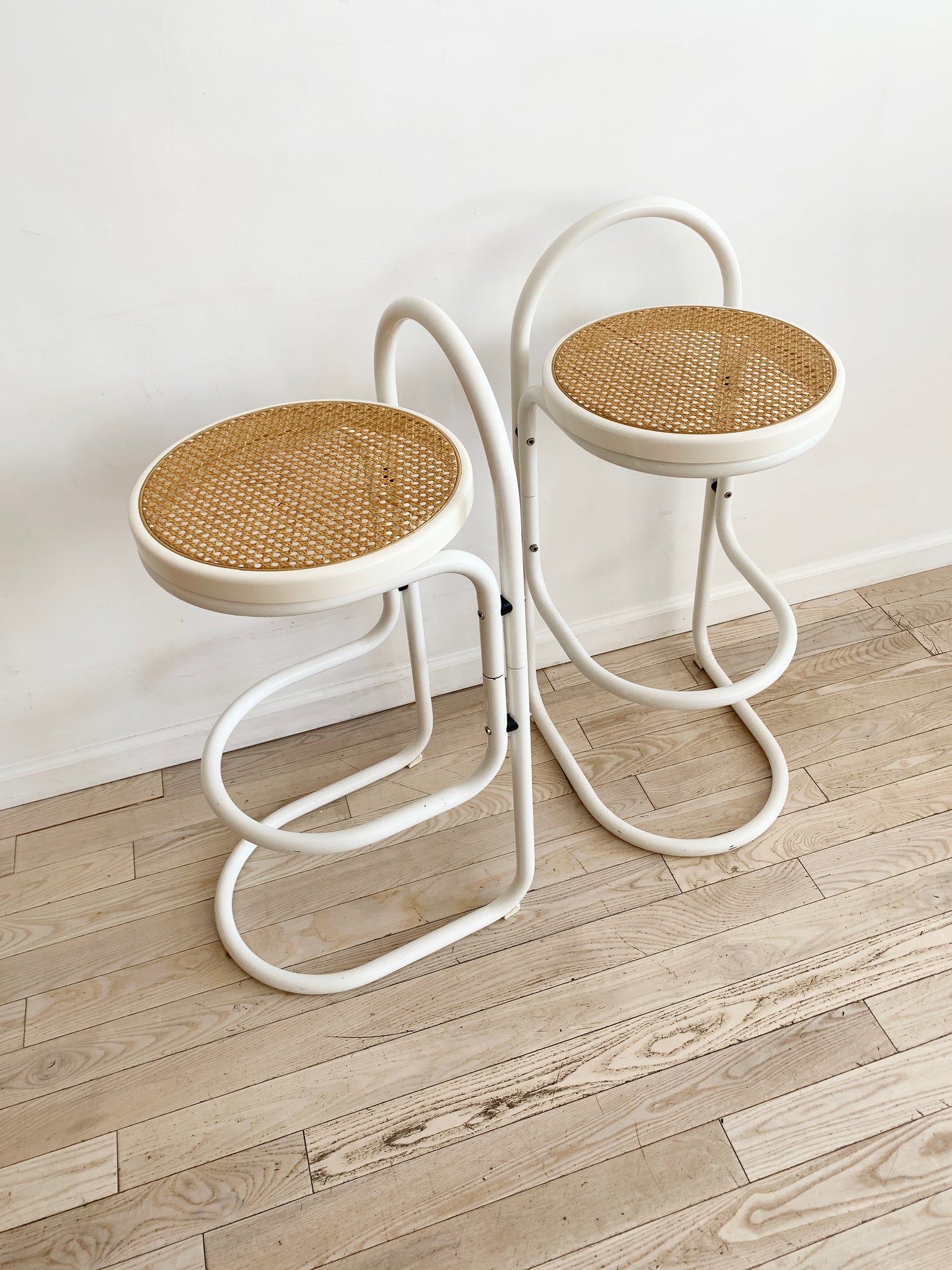 Pair of Vintage White Bent Metal and Cane Bar Stools